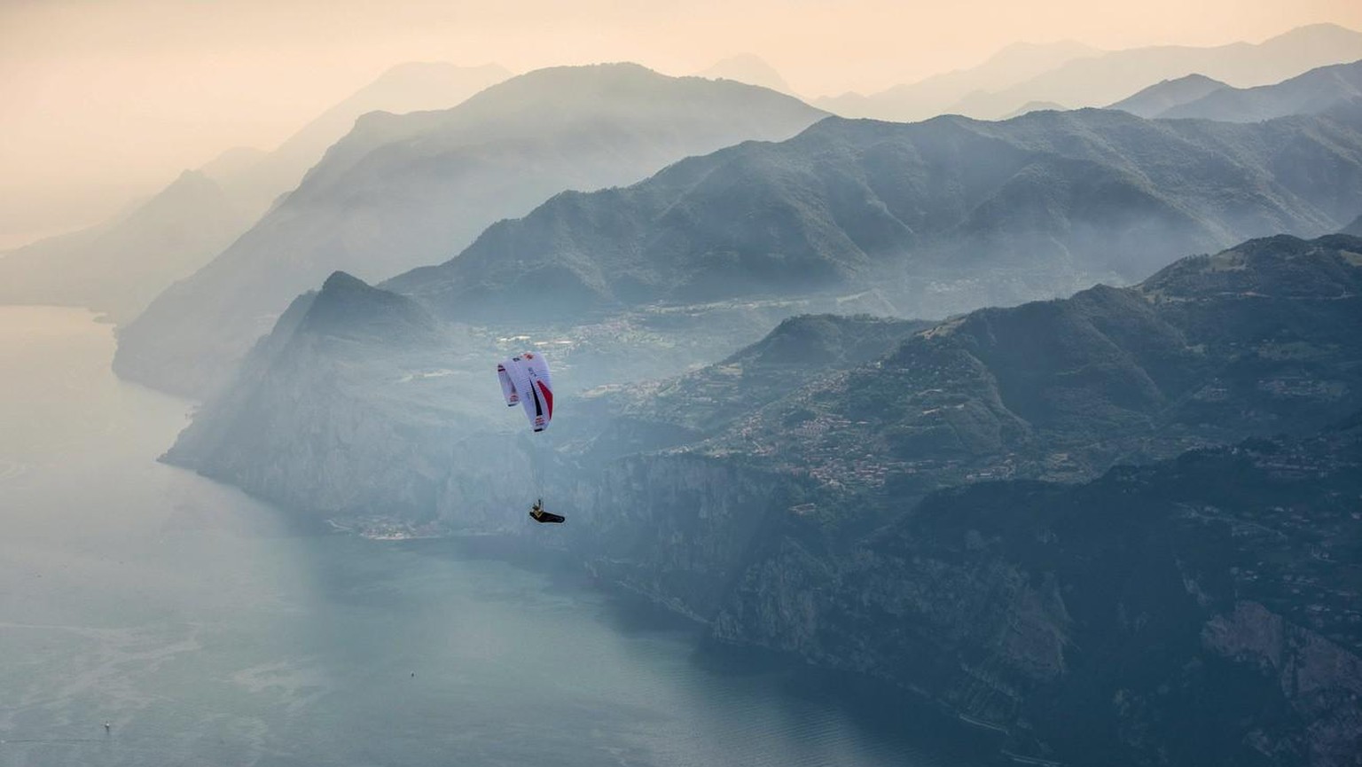 epa06073926 A handout photo made available by Global Newsroom on 07 July 2017 of Christian Maurer (SUI1) flying during the Red Bull X-Alps above Lake Garda, Italy, 06 July 2017. At this extreme advent ...