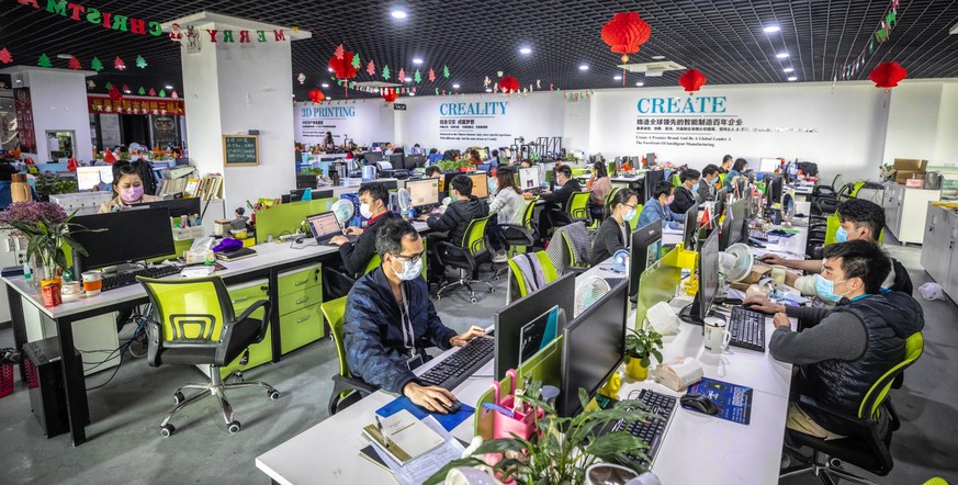 epa08274524 People work in an office at Creality 3D in Shenzhen, Guangdong province, China, 06 March 2020. Creality, a company that was founded in 2014, has been working at half capacity since the out ...
