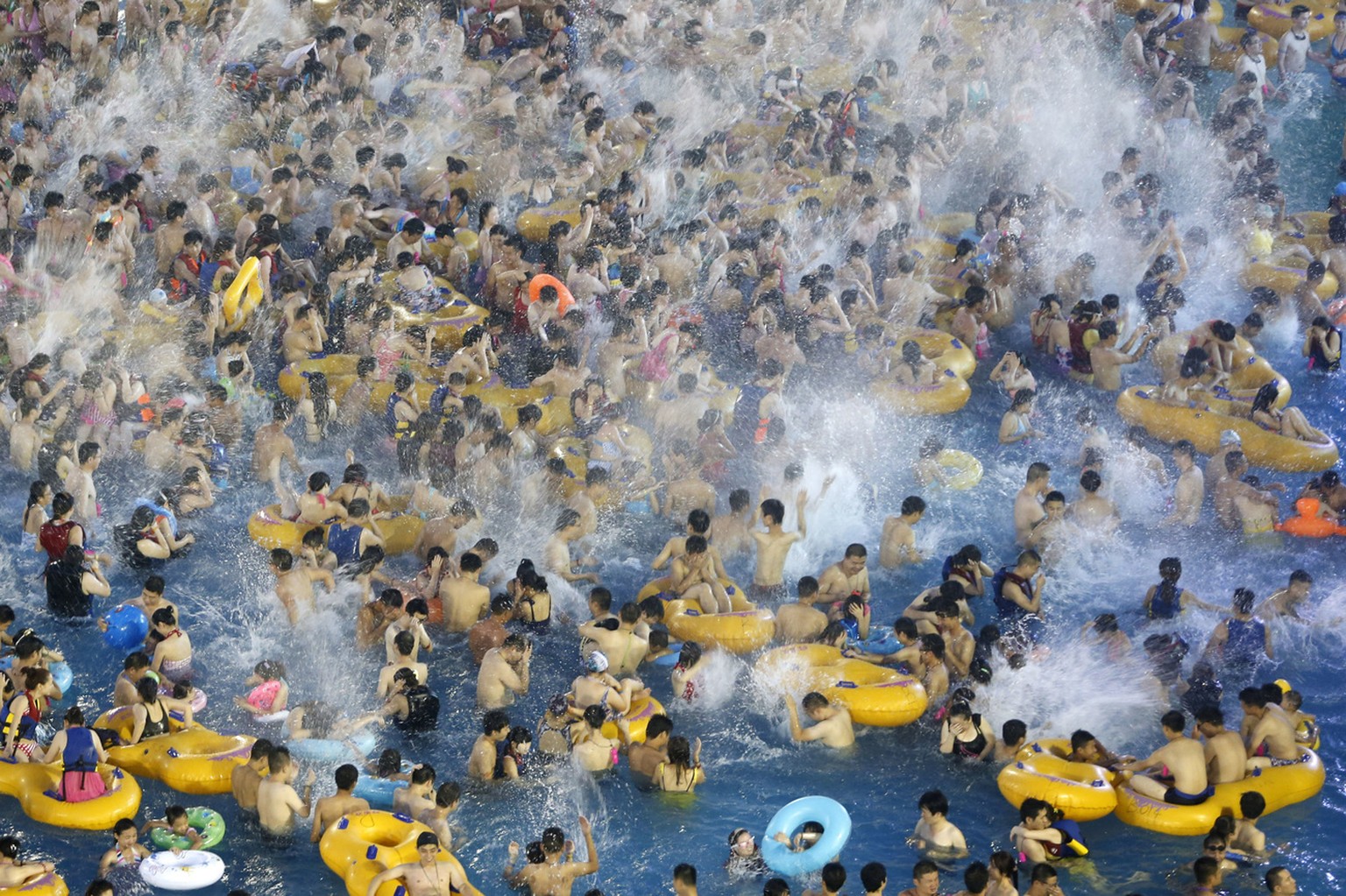Visitors at a water park enjoy themselves in Wuhan in central China&#039;s Hubei province Saturday, July 13, 2013. (AP Photo) CHINA OUT