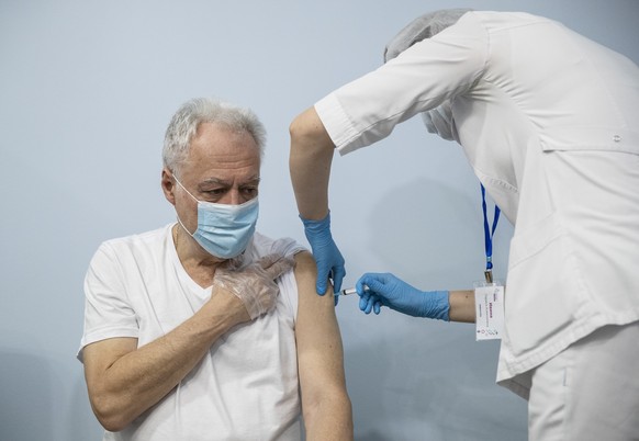 FILE - In this Jan. 20, 2021, file photo, a Russian medical worker, right, administers a shot of Russia&#039;s Sputnik V coronavirus vaccine to a patient in a vaccination center in Moscow, Russia. Rus ...