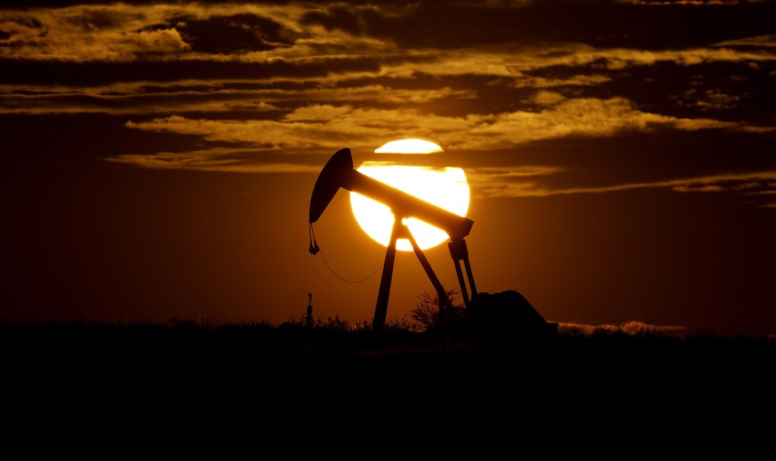 FILE - In this Wednesday, April 8, 2020, file photo, the sun sets behind an idle pump jack near Karnes City, Texas. Demand for oil continues to fall due to the new coronavirus outbreak. As demand for  ...