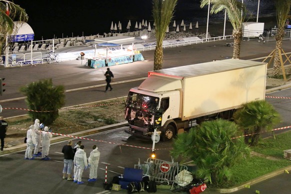 JAHRESRUECKBLICK 2016 - INTERNATIONAL - Authorities investigate a truck after it plowed through Bastille Day revelers in the French resort city of Nice, France, Thursday, July 14, 2016. France was rav ...