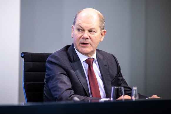 epa08881118 German Finance Minister and Vice Chancellor Olaf Scholz speaks during a press conference after a video conference with German Chancellor Merkel and German State Premiers about increased an ...