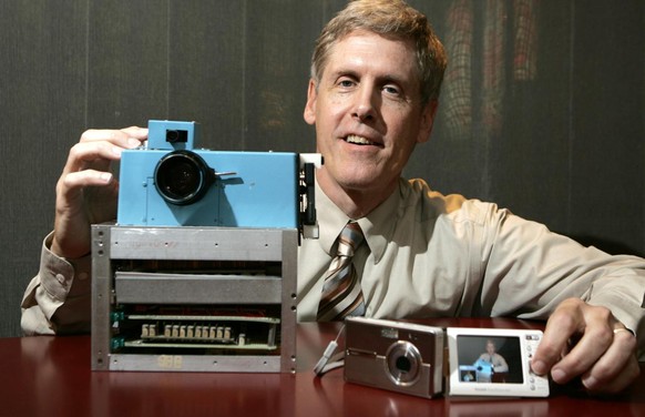 Steven J. Sasson, Eastman Kodak Co. project manager, shows his prototype digital camera he built in 1975 next to Kodak&#039;s latest digital camera the EasyShare One, at Kodak headquarters in Rocheste ...