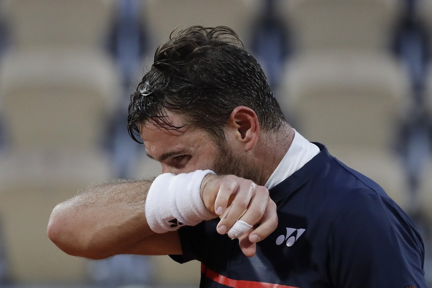 Switzerland&#039;s Stan Wawrinka wipes the sweat on his face in the third round match of the French Open tennis tournament against France&#039;s Hugo Gaston at the Roland Garros stadium in Paris, Fran ...