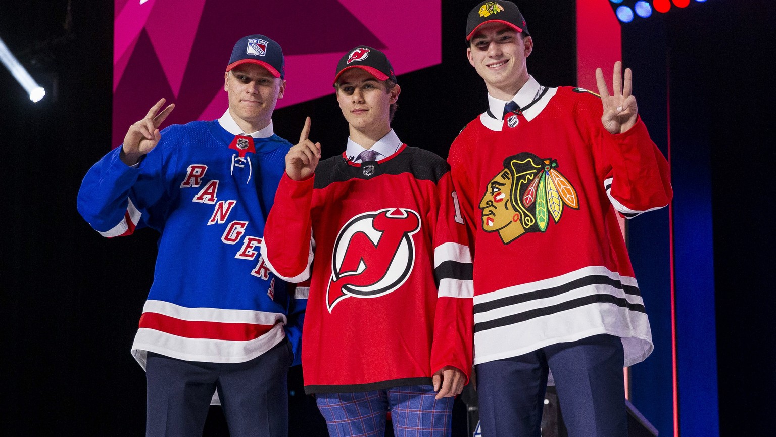 epa07664958 The first three picks of the 2019 NHL draft (L-R) second overall Kaapo Kakko of Finland, first overall Jack Hughes of the Unites States and third overall Kirby Dach of Canada, pose in thei ...