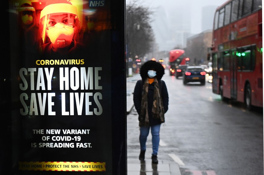 epa08934731 A public health notice to &#039;stay home&#039; at a bus stop in London, Britain, 13 January 2021. Britain&#039;s national health service (NHS) is coming under sever pressure as Covid-19 h ...