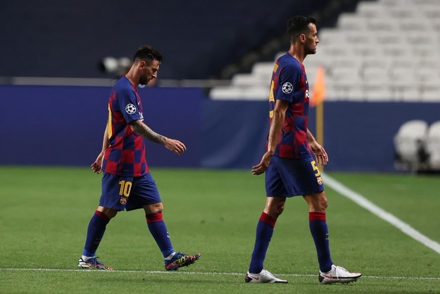 epa08604257 Lionel Messi (L) and Sergio Busquets of Barcelona react during the UEFA Champions League quarter final match between Barcelona and Bayern Munich in Lisbon, Portugal, 14 August 2020. EPA/Ra ...