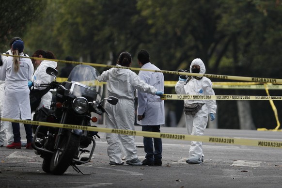 Forensic investigators and police work the scene where security secretary, Omar García Harfuch, was attacked by gunmen in the early morning hours in Mexico City, Friday, June 26, 2020. Heavily armed g ...