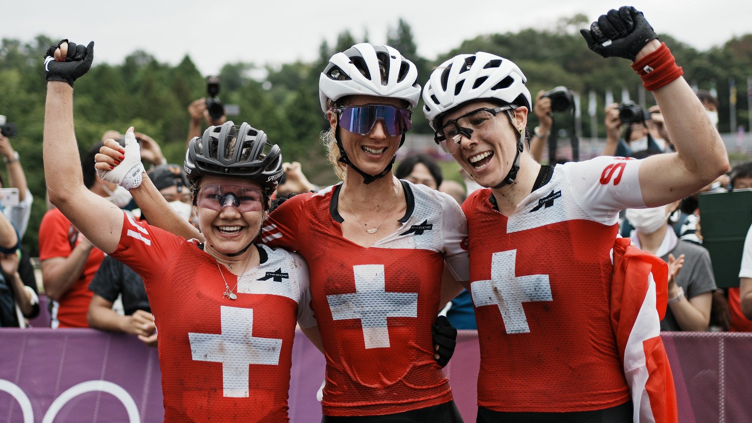 Switzerland&#039;s gold medalist Jolanda Neff center, silver medalist Sina Frei, left, and bronze medalist Linda Indergand (19) celebrate at the finish line after sweeping the podium during the women& ...