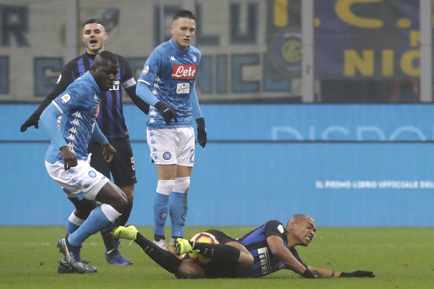 Inter Milan&#039;s Joao Mario, right, is fouled by Napoli&#039;s Kalidou Koulibaly during a Serie A soccer match between Inter Milan and Napoli, at the San Siro stadium in Milan, Italy, Wednesday, Dec ...