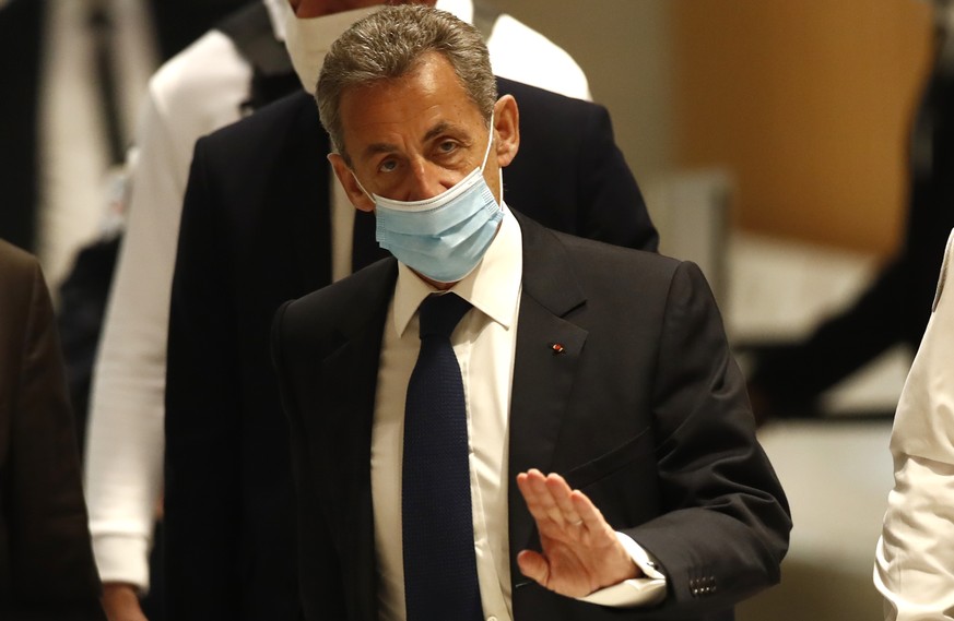 Former French President Nicolas Sarkozy arrives at the courtroom Monday, March 1, 2021 in Paris. The verdict is expected in a landmark corruption and influence-peddling trial that has put French forme ...