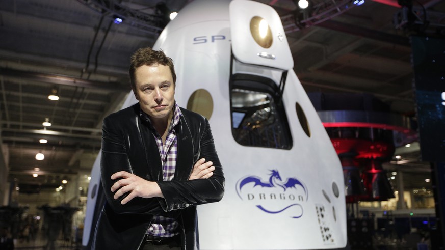 FILE - In this Thursday, May 29, 2014 file photo, Elon Musk, CEO and CTO of SpaceX, listens to a question during a news conference in front of the SpaceX Dragon V2 spacecraft, designed to ferry astron ...