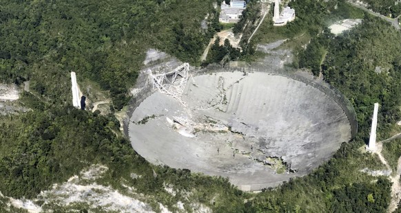 This photo provided by Aeromed shows the collapsed Radio Telescope in Arecibo, Puerto Rico, Tuesday, Dec. 1, 2020. The already damaged radio telescope that has played a key role in astronomical discov ...
