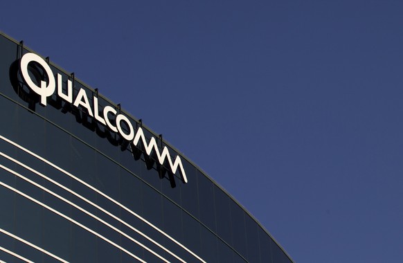FILE - In this Nov. 2, 2011, file photo, a sign sits atop the Qualcomm headquarters building in San Diego. Qualcomm is raising its takeover bid for NXP Semiconductors by nearly 16 percent to about $43 ...