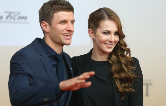 BERLIN, GERMANY - NOVEMBER 10: Thomas Mueller of the German national football team arrives with his wife Lisa Mueller for the movie premiere &#039;Die Mannschaft&#039; at Sony Center Berlin on Novembe ...