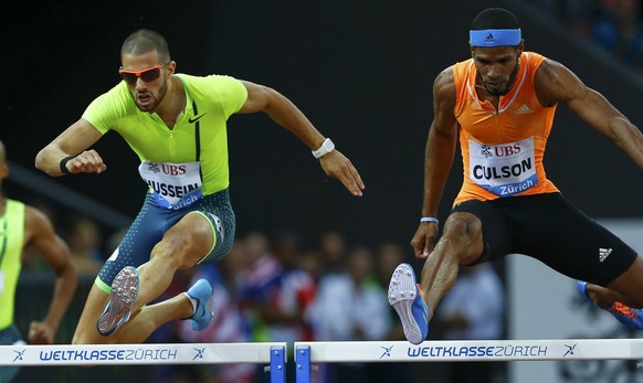 Javier Culson (R) of Puerto Rico competes next to Kariem Hussein of Switzerland in the men&#039;s 400m hurdles event during the Weltklasse Diamond League meeting at the Letzigrund stadium in Zurich Au ...