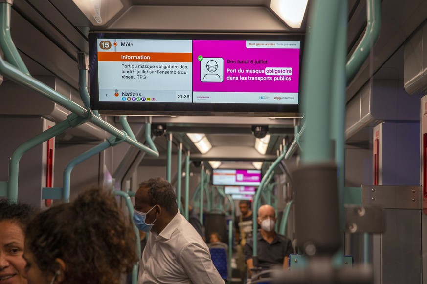 epa08525783 An information display reads &#039;From Monday July 6 wearing a mask obligatory in publics transports&#039; is displayed on a screen in a tramway of the Transports publics genevois, TPG, ( ...