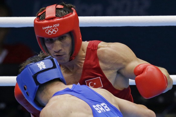 FILE - In this Aug. 2, 2012 file photo Turkey&#039;s Adem Kilicci, right, fights Serbia&#039;s Alexandar Drenovak during their men&#039;s light 75-kg boxing match at the 2012 Summer Olympics in London ...