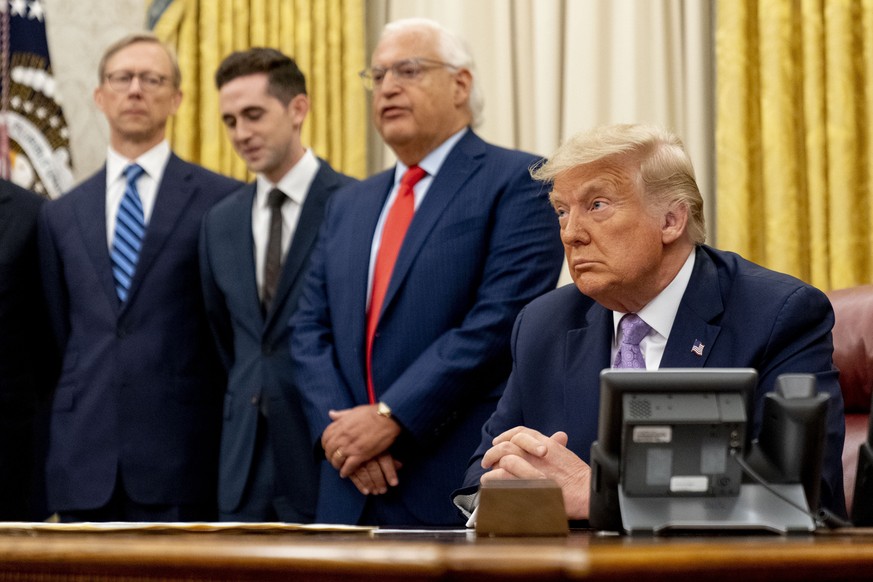 U.S. Ambassador to Israel David Friedman, second from right, accompanied by President Donald Trump, right, U.S. special envoy for Iran Brian Hook, left, and Avraham Berkowitz, Assistant to the Preside ...