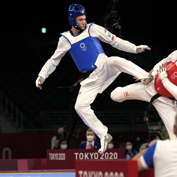 Maksim Khramtsov of the Russian Olympic Committee, left, attacks Jordan&#039;s Julyana Al-Sadeq during taekwondo men&#039;s 80kg match at the 2020 Summer Olympics, Monday, July 26, 2021, in Tokyo, Jap ...