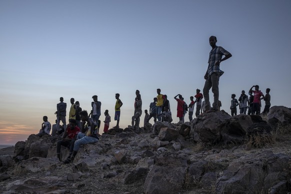 People who fled the conflict in Ethiopia&#039;s Tigray region, stand on a hill top over looking Umm Rakouba refugee camp in Qadarif, eastern Sudan, Thursday, Nov. 26, 2020. Ethiopia&#039;s prime minis ...