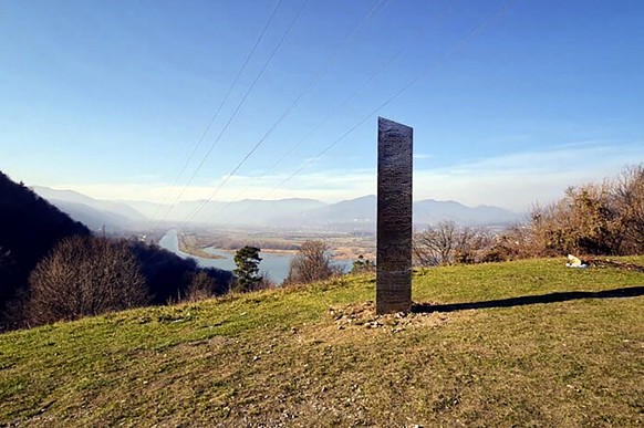 FILE - In this Nov. 27, 2020, file photo, a metal structure sticks out from the ground on the Batca Doamnei hill, outside Piatra Neamt, northern Romania. Days after the arrival and swift disappearance ...