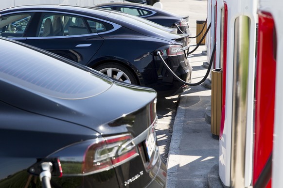 FILE - In this June 4, 2016 file photo, electric Tesla cars parked at a supercharger facility in Sarpsborg, Norway. Norway wants to get rid of gasoline-fueled cars, plans to become carbon neutral by 2 ...