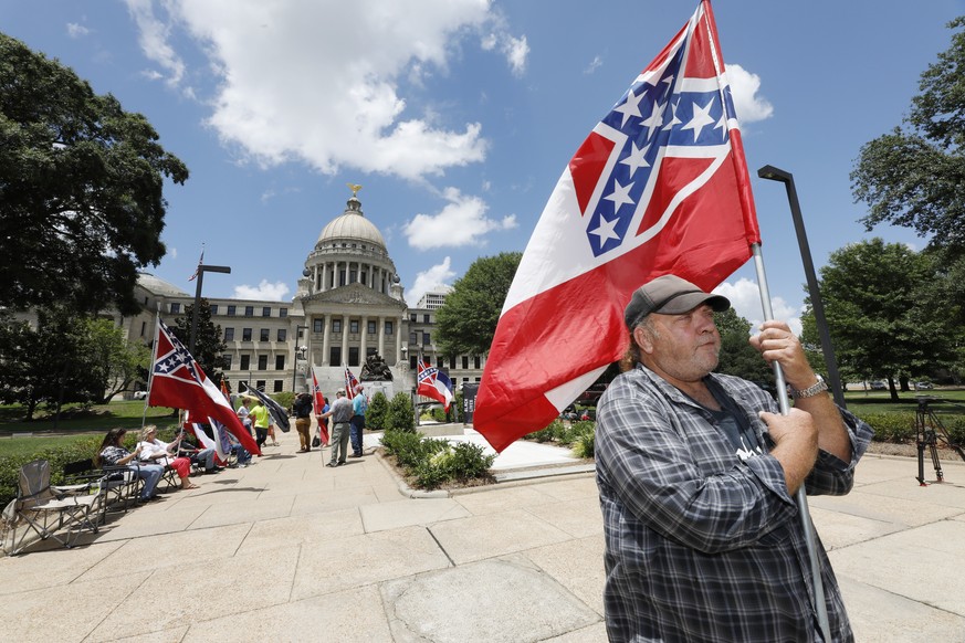 &quot;I love this flag,&quot; states David Flynt of Hattiesburg, while standing outside the state Capitol with other current Mississippi flag supporters in Jackson, Miss., Sunday, June 28, 2020. Lawma ...