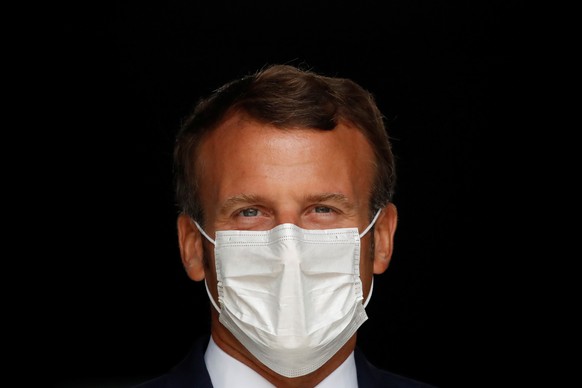 epa08630912 French President Emmanuel Macron, wearing a protective face mask, visits a site of pharmaceutical group Seqens, a global leader on the production of active pharmaceutical ingredients, to m ...