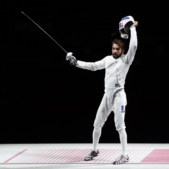 epa09365041 Romain Cannone of France celebrates after winning the gold medal during the men&#039;s Epee Individual Gold Medal Bout of the Fencing events of the Tokyo 2020 Olympic Games at the Makuhari ...