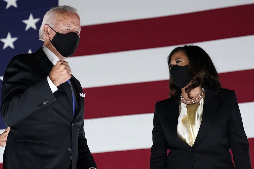 FILE- In this Aug. 20, 2020, file photo Democratic presidential candidate former Vice President Joe Biden pumps his fist on stage with his running mate Sen. Kamala Harris, D-Calif., during the fourth  ...