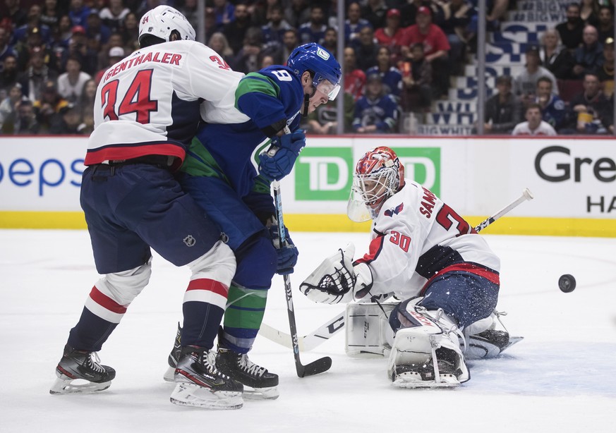 Washington Capitals goalie Ilya Samsonov, right, of Russia, stops Vancouver Canucks&#039; J.T. Miller (9) as Washington&#039;s Jonas Siegenthaler, of Switzerland, defends during the second period of a ...