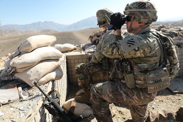 epa07832230 A handout photo made available by the US Army shows soldiers from the 1-108th Cavalry Regiment of the 48th Infantry Brigade Combat Team scanning key terrain and provide security during a k ...