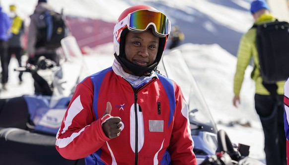 Celine Marti of Haiti thumbs up at the finish line after the first run of a women&#039;s giant slalom, at the alpine ski World Championships, in Cortina d&#039;Ampezzo, Italy, Thursday, Feb. 18, 2021. ...
