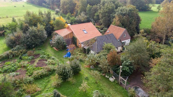epaselect epa07922540 A drone photo of the farm, where a father and six children had been living in the cellar, In Ruinerwold, The Netherlands, 15 October 2019. The family lived in the cellar for year ...