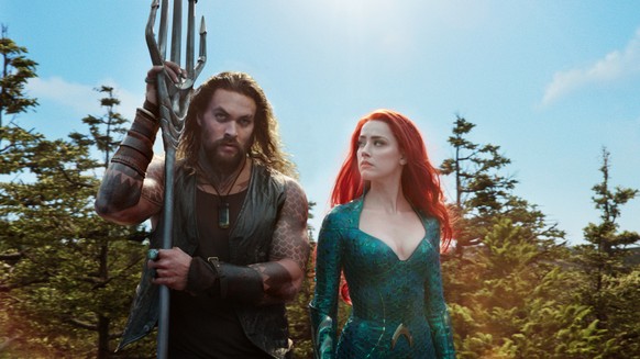 This image released by Warner Bros. Pictures shows Jason Momoa, left, and Amber Heard in a scene from the film, &quot;Aquaman.&quot; (Warner Bros. Pictures via AP)