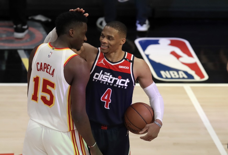 Washington Wizards&#039; Russell Westbrook (4) is congratulated by Atlanta Hawks&#039; Clint Capela at the end of an NBA basketball game Monday, May 10, 2021, in Atlanta. Westbrook recorded his 182nd  ...