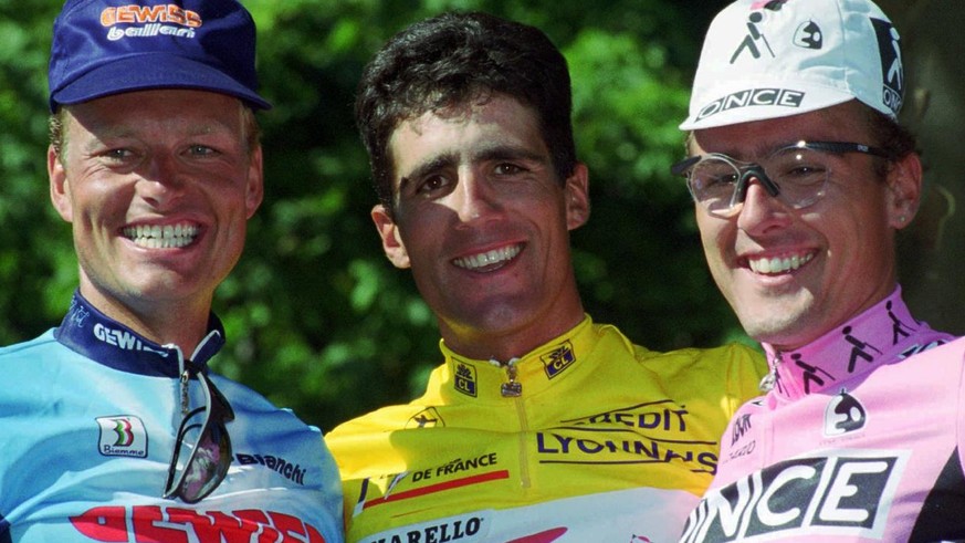 Tour de France winner Miguel Indurain of Spain, center, poses with second-placed Alex Zulle of Switzerland, right, and Bjarne Riis of Denmark after the final stage in Paris Sunday July 23, 1995. Indur ...