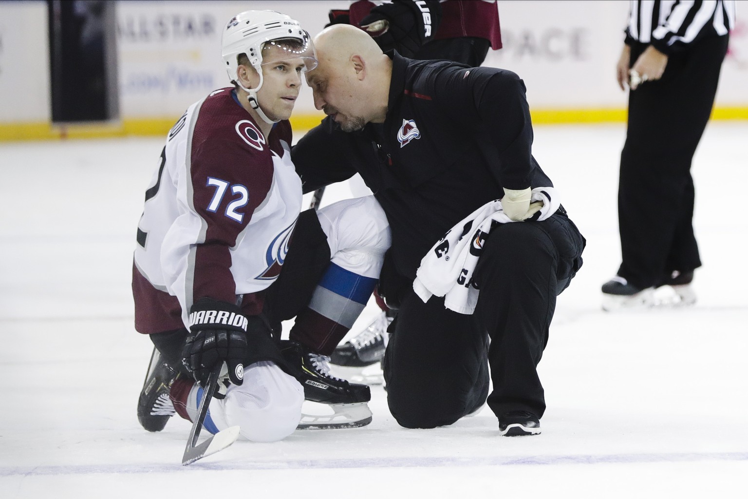A trainer checks on Colorado Avalanche&#039;s Joonas Donskoi (72) after he was hurt during the first period of the team&#039;s NHL hockey game against the New York Rangers on Tuesday, Jan. 7, 2020, in ...