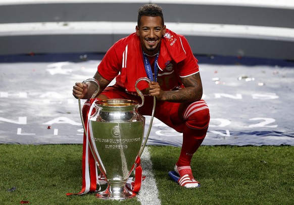 Bayern&#039;s Jerome Boateng celebrates with the trophy after Munich won the Champions League final soccer match between Paris Saint-Germain and Bayern Munich at the Luz stadium in Lisbon, Portugal, S ...