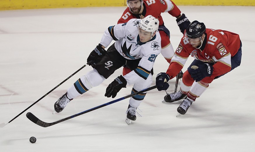 San Jose Sharks right wing Timo Meier, center, Florida Panthers center Aleksander Barkov, right, and Florida Panthers defenseman Aaron Ekblad, left, battle for control of the puck during the third per ...
