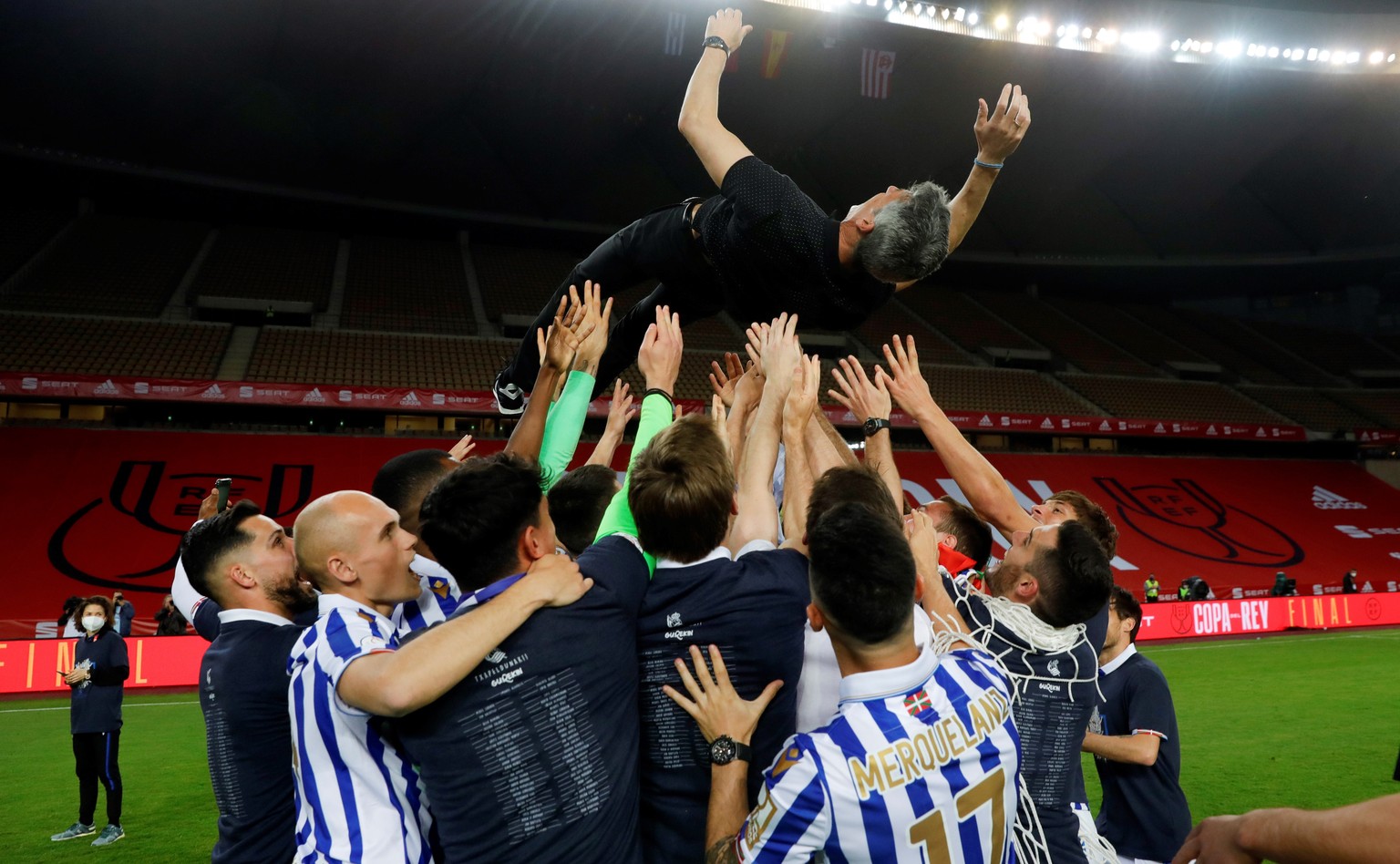 epa09114773 A handout photo made available by the Spanish Royal Soccer Federation (RFEF) shows shows Real Sociedad players throwing head coach Imaol Alguacil up after winning the 2020 Spanish King&#03 ...