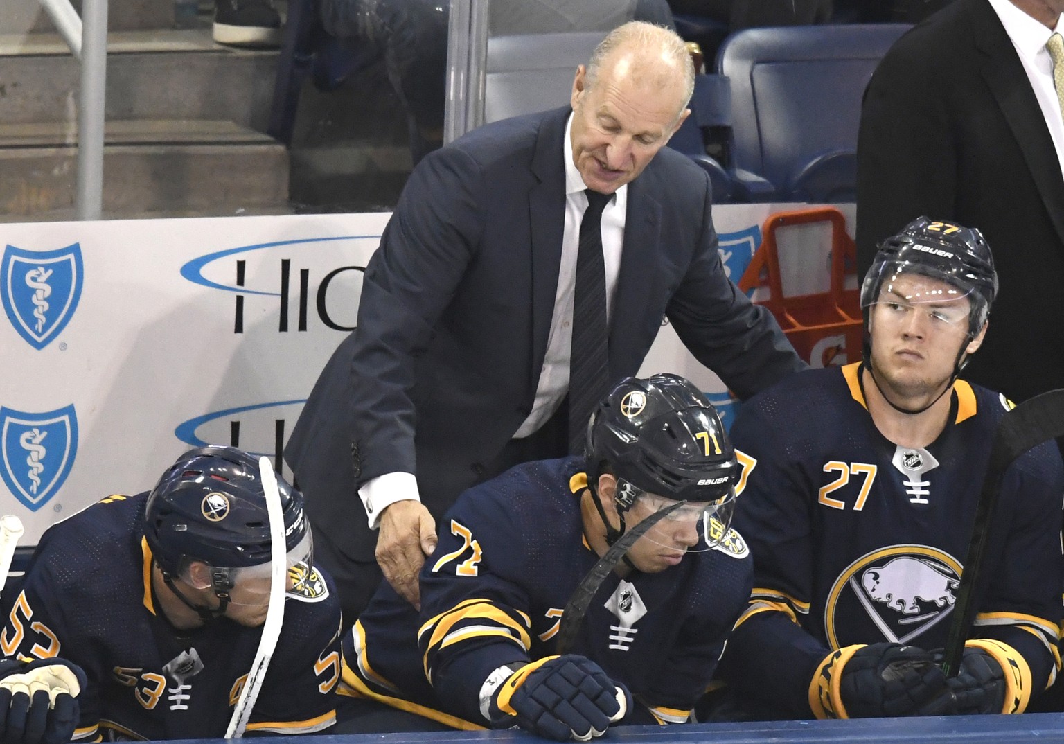 Buffalo Sabres head coach Ralph Krueger, top, talks with Sabres players Jeff Skinner (53), Evan Rodrigues (71) and Curtis Lazar (27) during an NHL preseason hockey game against the Pittsburgh Penguins ...