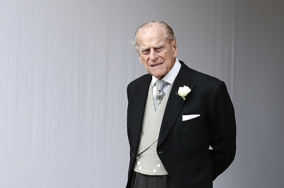 FILE - In this file photo dated Friday, Oct. 12, 2018, Britain&#039;s Prince Philip waits for the bridal procession following the wedding of Princess Eugenie of York and Jack Brooksbank at St George&# ...