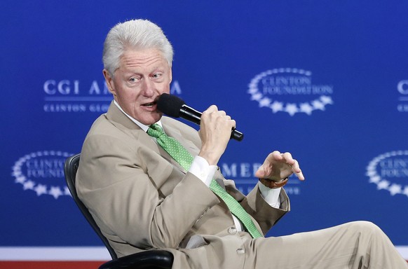 FILE - In this June 25, 2014, file photo, former President Bill Clinton, left, speaks with Zappos.com CEO Tony Hsieh during a forum on the final day of the annual gathering of the Clinton Global Initi ...