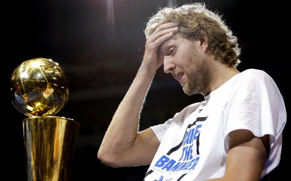 Dallas Mavericks&#039; Dirk Nowitzki, of Germany, fights back tears as fans cheer following his introduction during a celebration following the team&#039;s victory parade, Thursday, June 16, 2011, in  ...