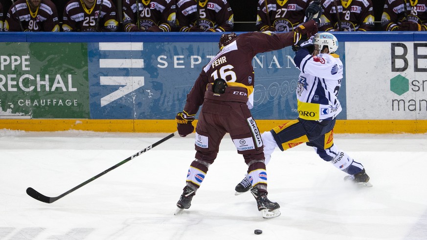 $, left, vies for the puck with $, right, during the second leg of the National League Swiss Championship final playoff between Geneve-Servette HC and EV Zug, at the ice stadium Les Vernets, in Geneva ...