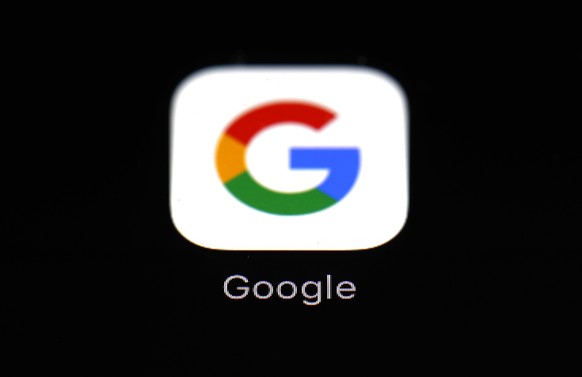 FILE - This March 19, 2018 file photo shows a Google app in Baltimore. Apple and Google launched a major joint effort, Friday, April 10, 2020, to leverage smartphone technology contain the COVID-19 pa ...