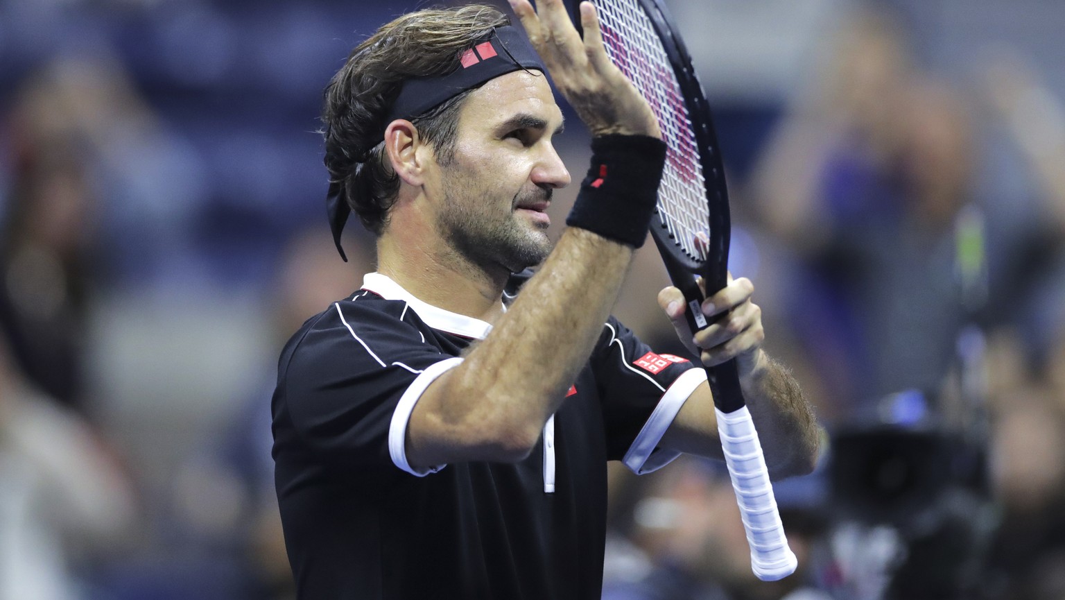 Roger Federer acknowledges the crowd after defeating Sumit Nagal during the first round of the U.S. Open tennis tournament in New York, Monday, Aug. 26, 2019. Federer won 4-6, 6-1, 6-1, 6-4. (AP Photo ...